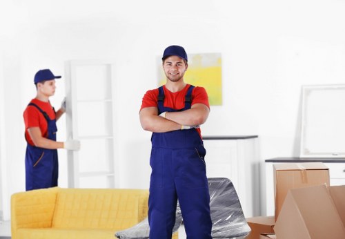 Removal team managing boxes and furniture in a Lewisham property