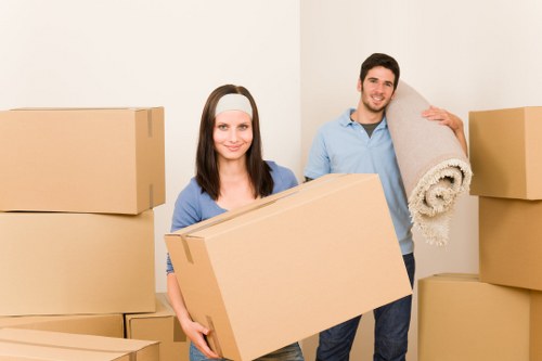 Local house removal team carrying furniture through a Lewisham property